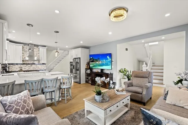 a living room with furniture and a chandelier
