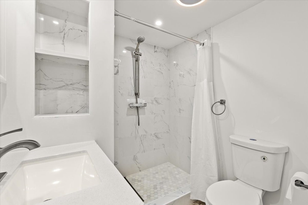 6 Arion Street Boston, MA 02125 - Photo 31 of 42 a bathroom with a shower and a toilet