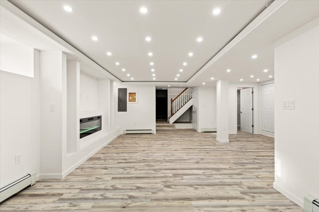 6 Arion Street Boston, MA 02125 - Photo 33 of 42 a view of an empty room with a fireplace