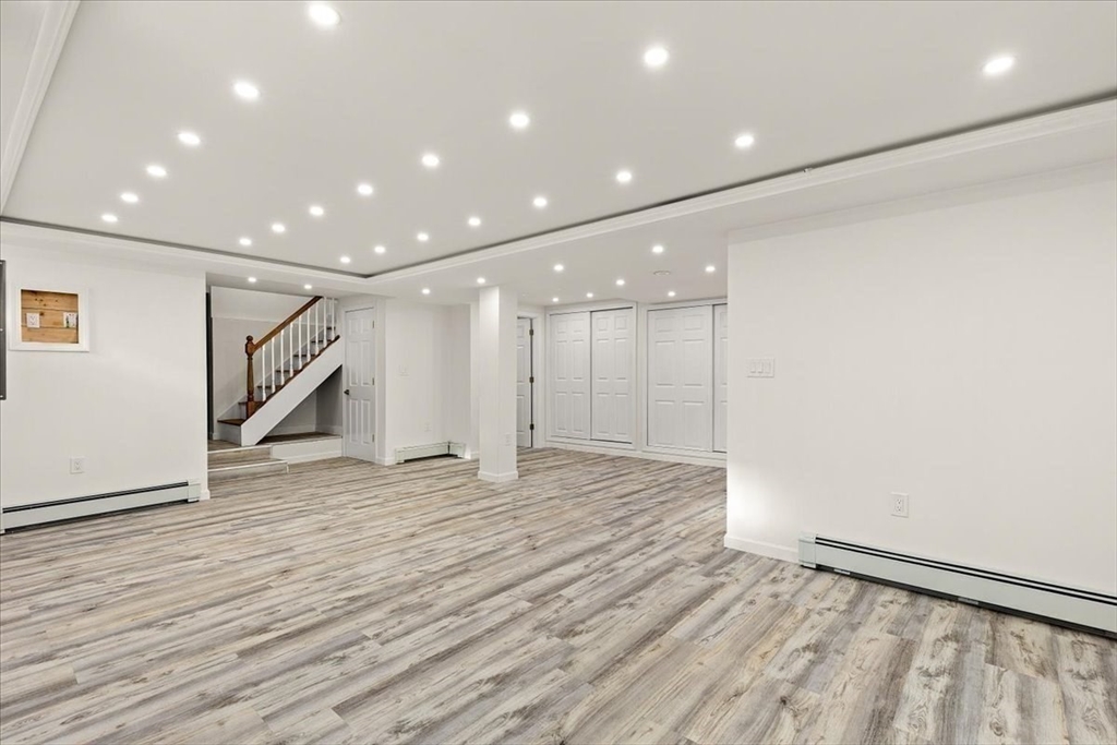 6 Arion Street Boston, MA 02125 - Photo 34 of 42 a view of an empty room with wooden floor and a window