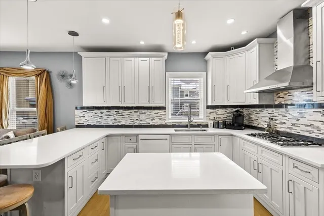 a large kitchen with stainless steel appliances kitchen island granite countertop a sink and cabinets