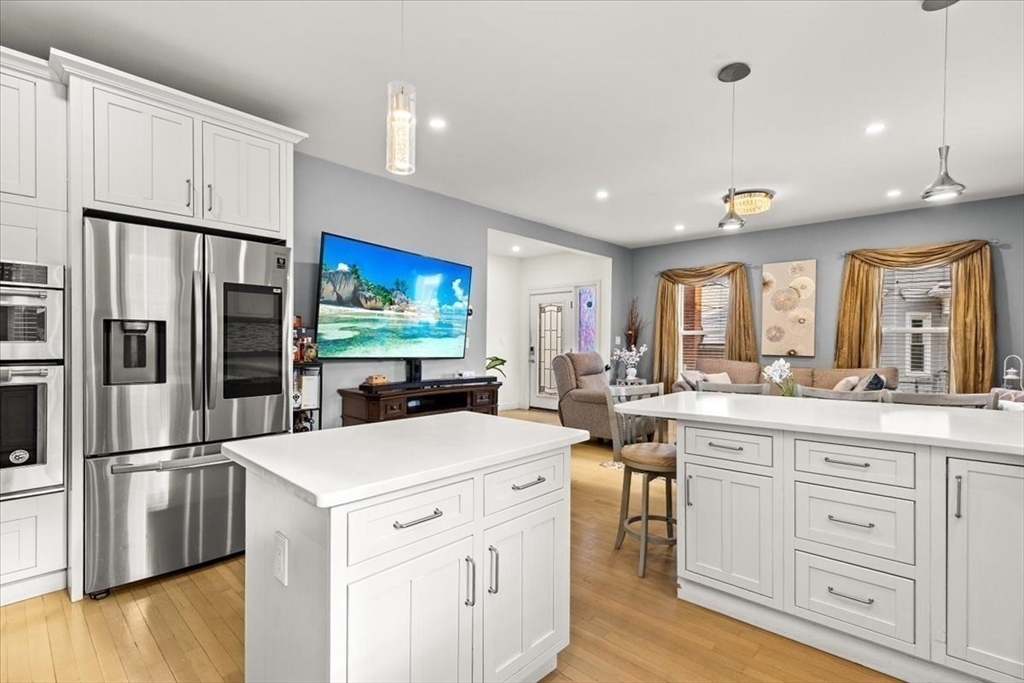 6 Arion Street Boston, MA 02125 - Photo 7 of 42 a kitchen with white cabinets and stainless steel appliances