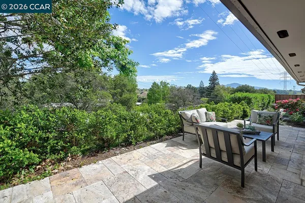a view of a backyard with sitting area