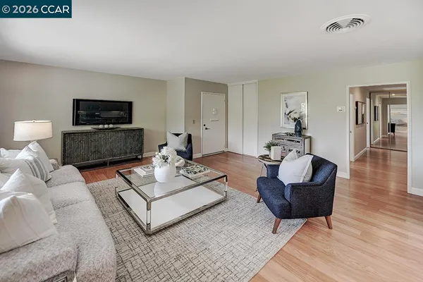 a living room with couches and a flat screen tv