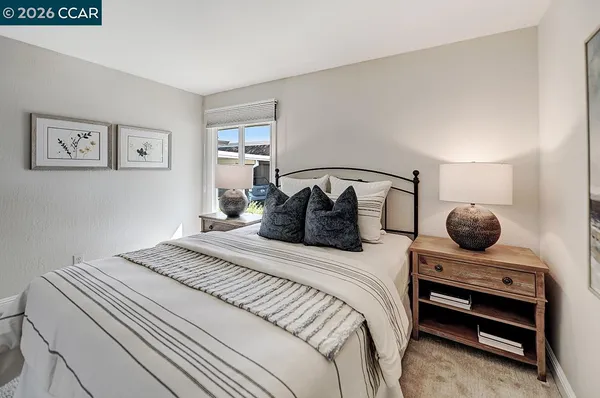 a bedroom with a bed and a painting on the wall