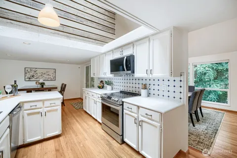 a kitchen with a stove sink and a microwave