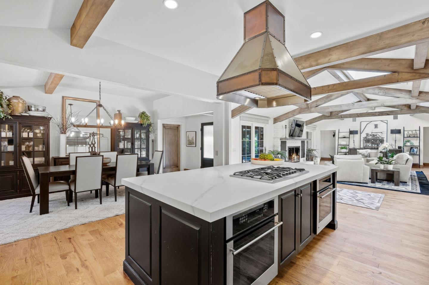 11627 Hidden Hills Road Carmel Valley, CA 93924 - Photo 21 of 62 a open kitchen with stainless steel appliances granite countertop a stove cabinets a dining table and chairs with wooden floor