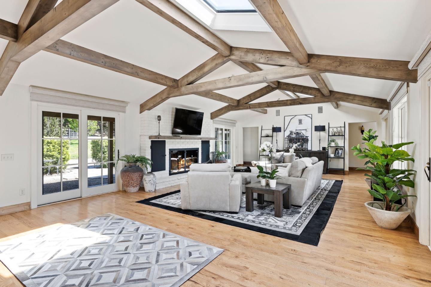 11627 Hidden Hills Road Carmel Valley, CA 93924 - Photo 25 of 62 a living room with furniture a fireplace and a table