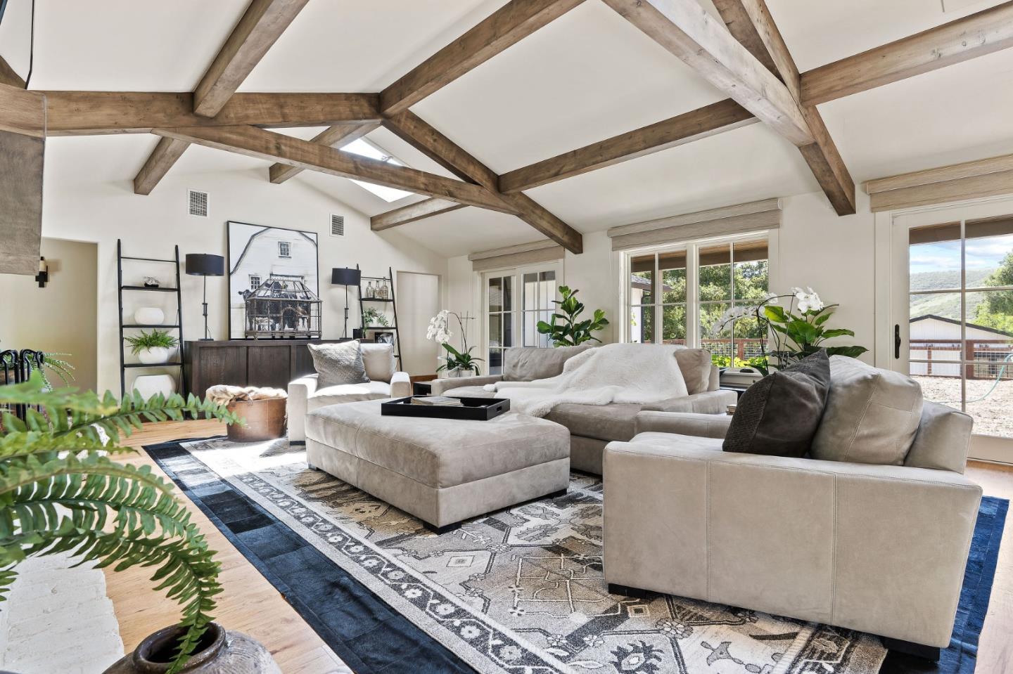 11627 Hidden Hills Road Carmel Valley, CA 93924 - Photo 27 of 62 a living room with furniture and a chandelier
