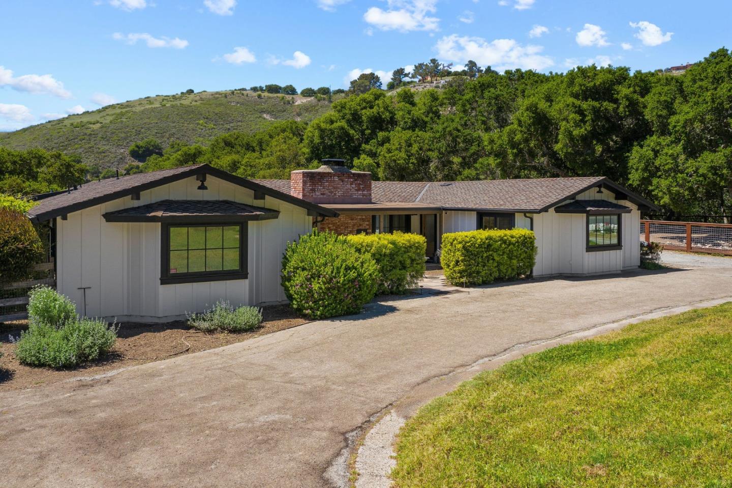 11627 Hidden Hills Road Carmel Valley, CA 93924 - Photo 3 of 62 a front view of a house with a yard and garage