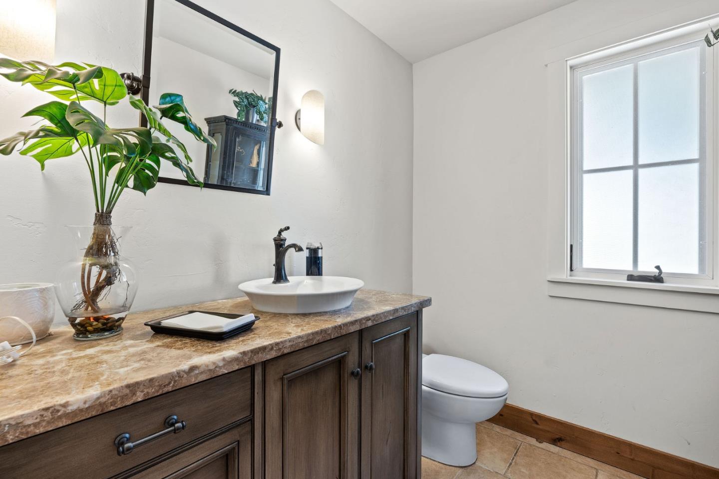 11627 Hidden Hills Road Carmel Valley, CA 93924 - Photo 35 of 62 a bathroom with a granite countertop sink a toilet and a mirror