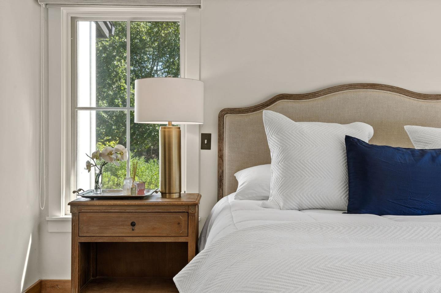 11627 Hidden Hills Road Carmel Valley, CA 93924 - Photo 44 of 62 a bed sitting in a bedroom next to a window