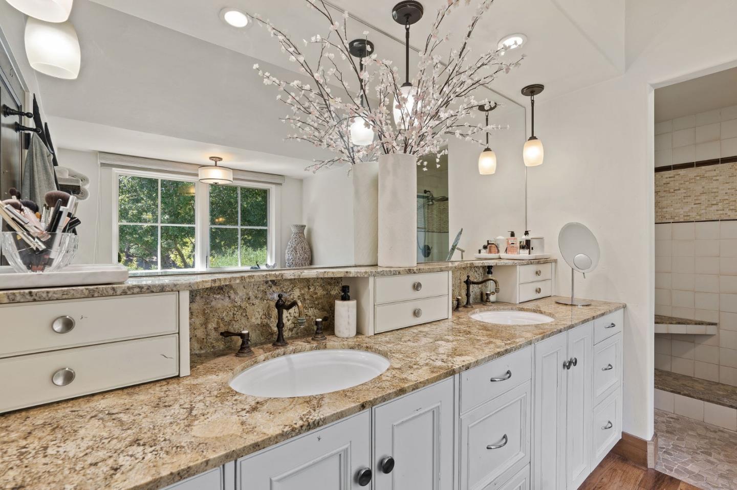 11627 Hidden Hills Road Carmel Valley, CA 93924 - Photo 45 of 62 a bathroom with a granite countertop double vanity sink mirror and window