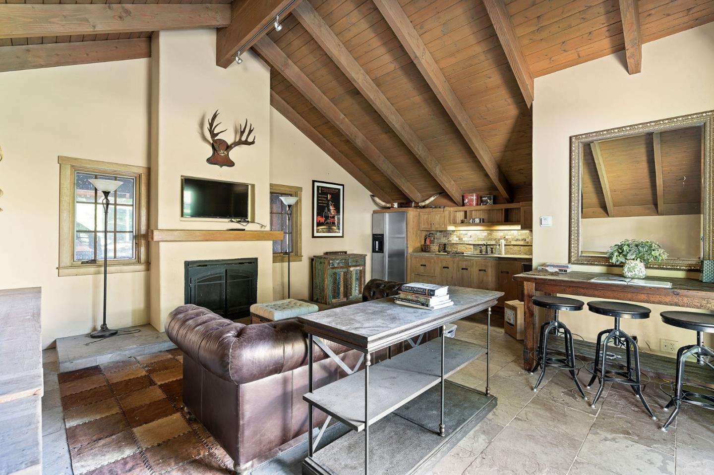 11627 Hidden Hills Road Carmel Valley, CA 93924 - Photo 60 of 62 a living room with furniture a fireplace and a flat screen tv