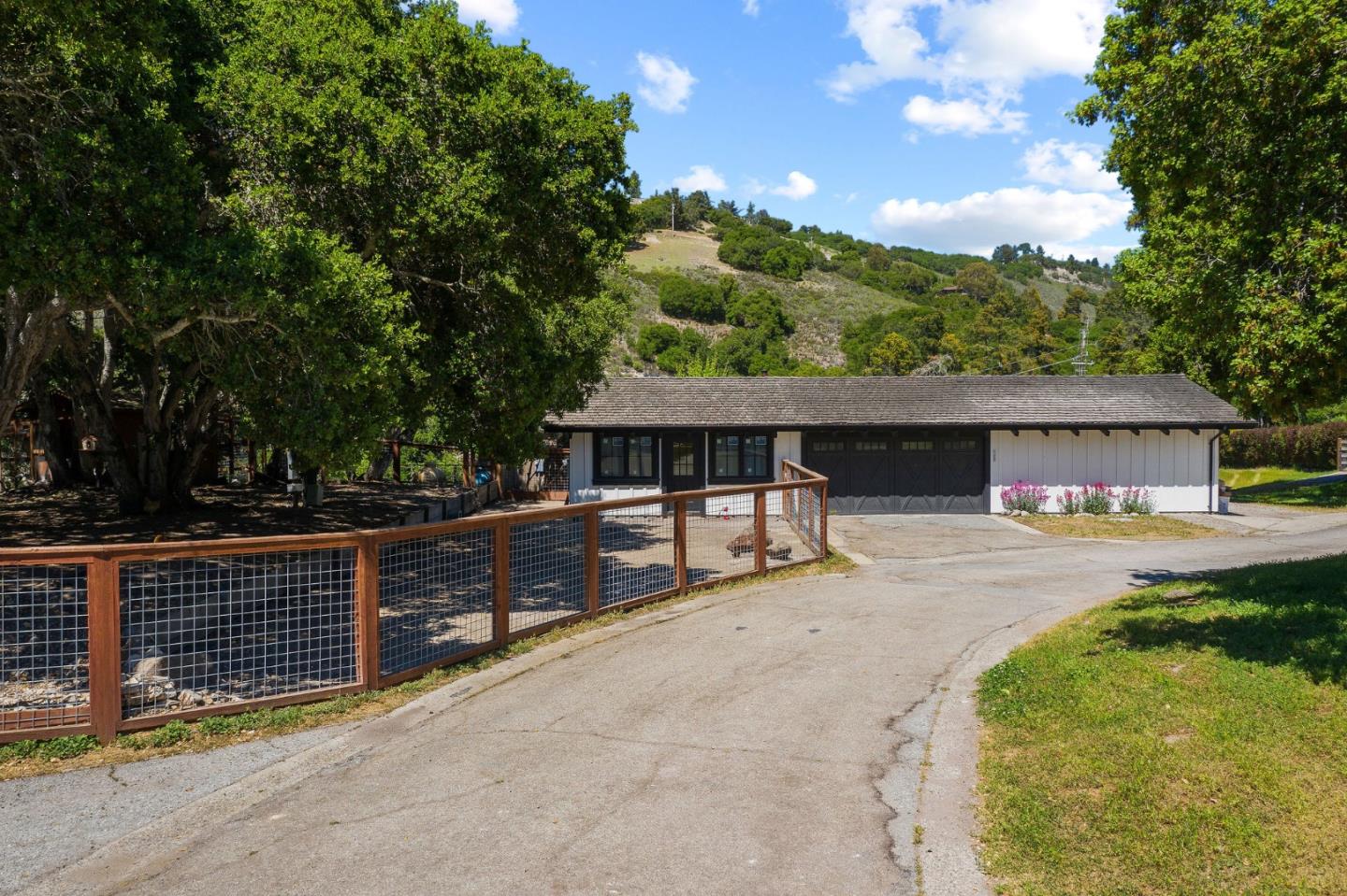 11627 Hidden Hills Road Carmel Valley, CA 93924 - Photo 7 of 62 a front view of a house with a yard