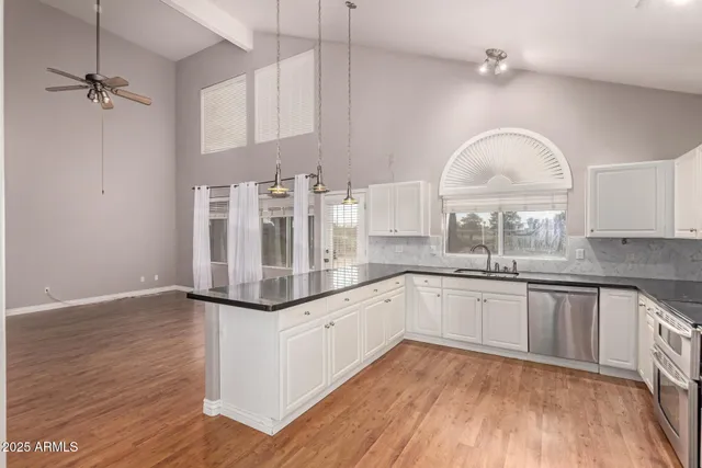 a kitchen with granite countertop white cabinets and white appliances