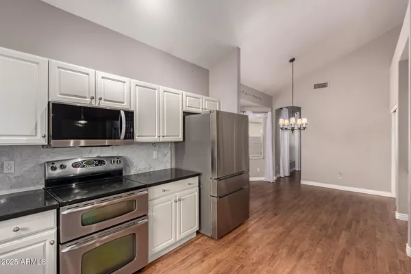 a kitchen with stainless steel appliances a refrigerator microwave and sink