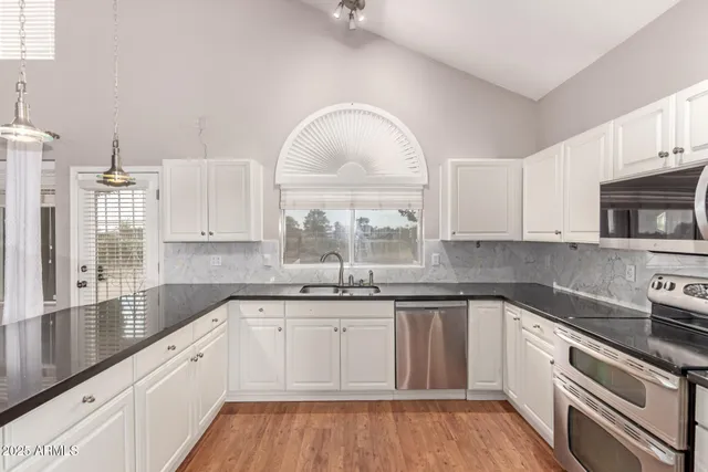 a kitchen with a sink cabinets and window