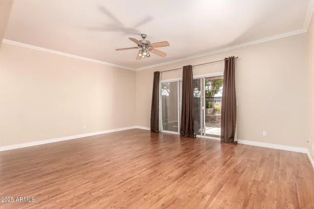 a view of an empty room with wooden floor