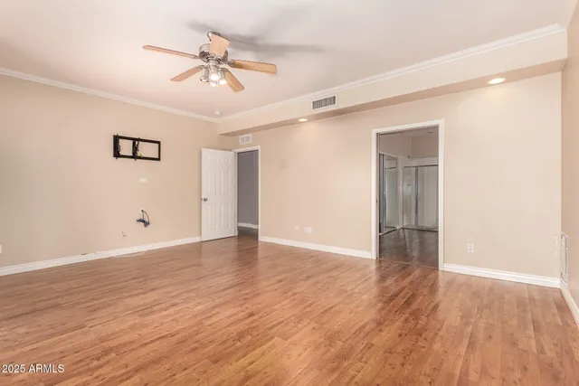 a view of an empty room with wooden floor