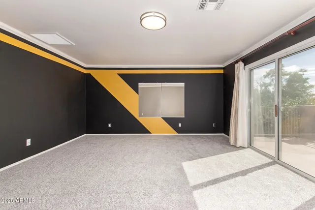 an empty room with chandelier fan