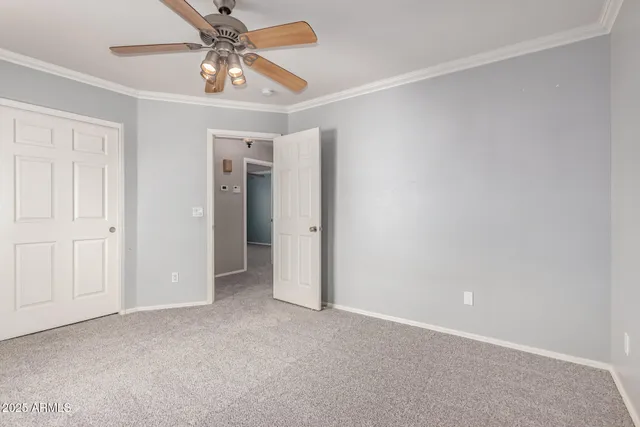 a view of an empty room and a ceiling fan