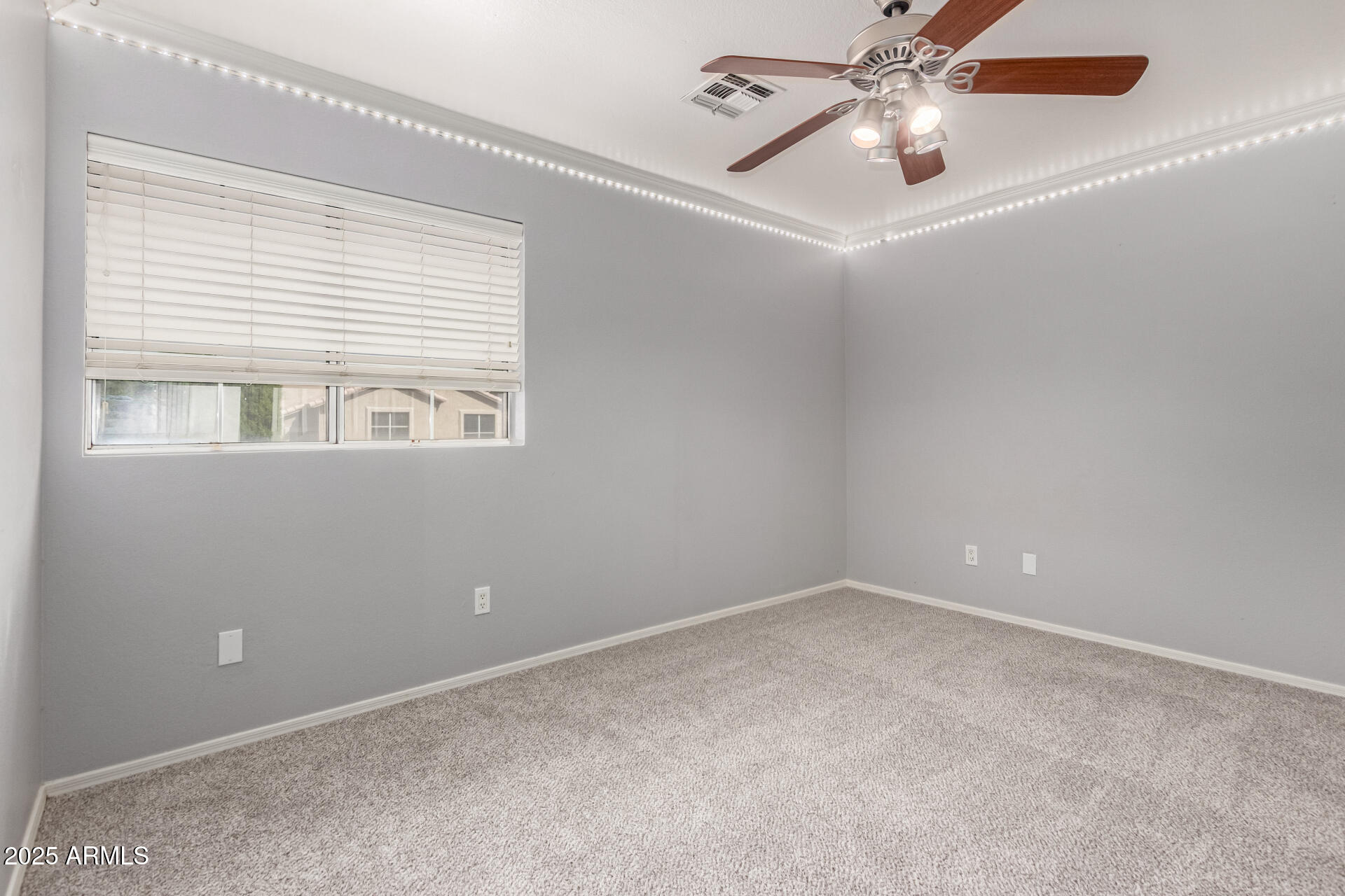 1284 North Conner Avenue Gilbert, AZ 85209 - Photo 30 of 45 an empty room with a window and a fan
