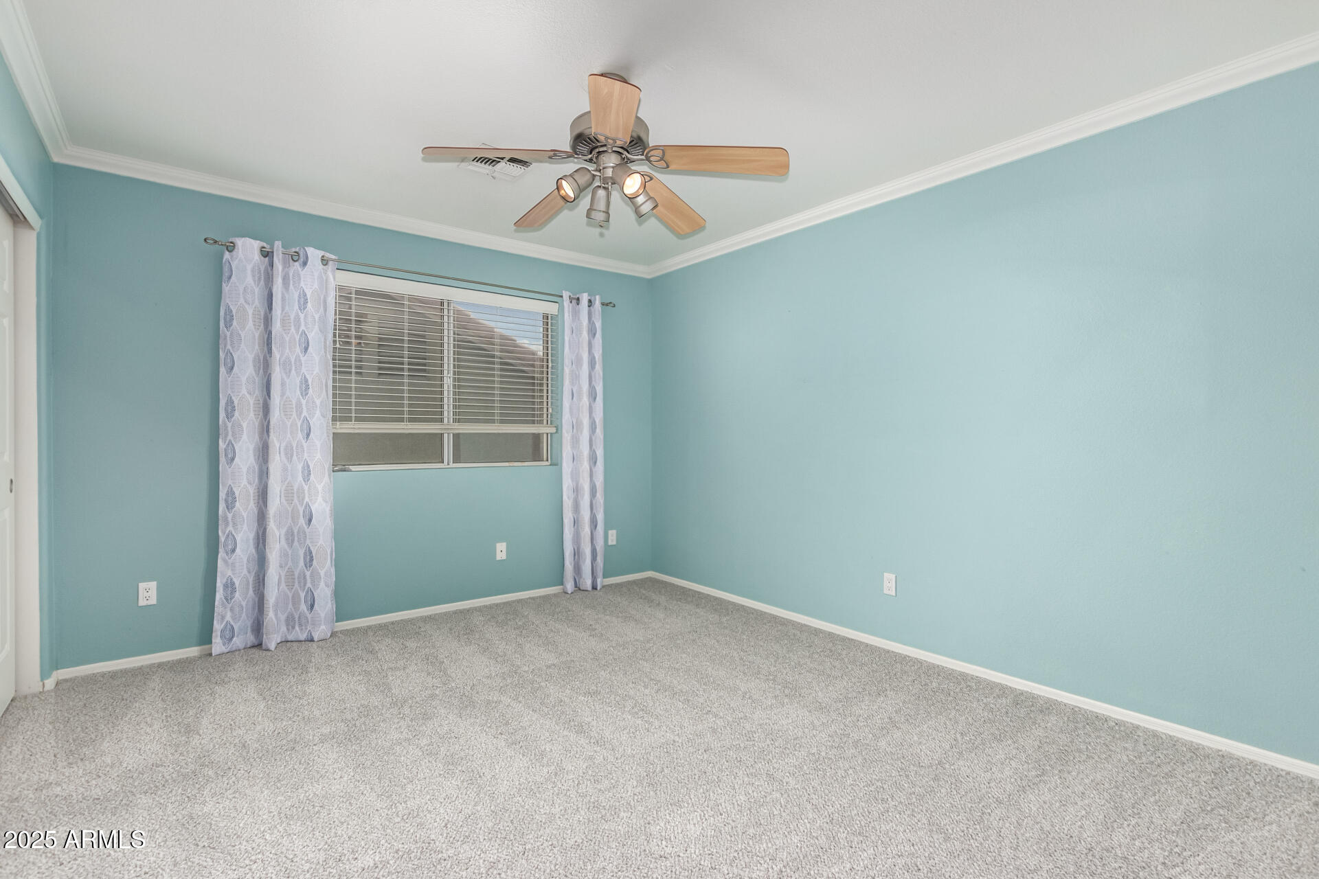 1284 North Conner Avenue Gilbert, AZ 85209 - Photo 33 of 45 an empty room with a chandelier fan and windows
