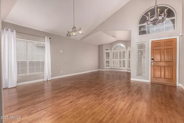 a view of livingroom with furniture wooden floor chandelier