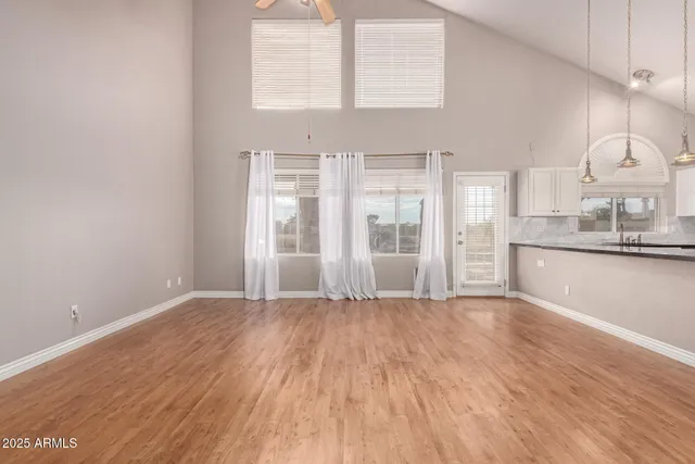 a view of a kitchen with wooden floor and windows