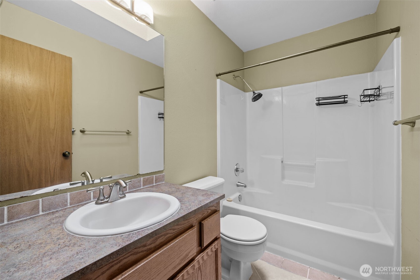 21641 Southeast 266th Street Maple Valley, WA 98038 - Photo 15 of 40 a bathroom with a sink a toilet and shower