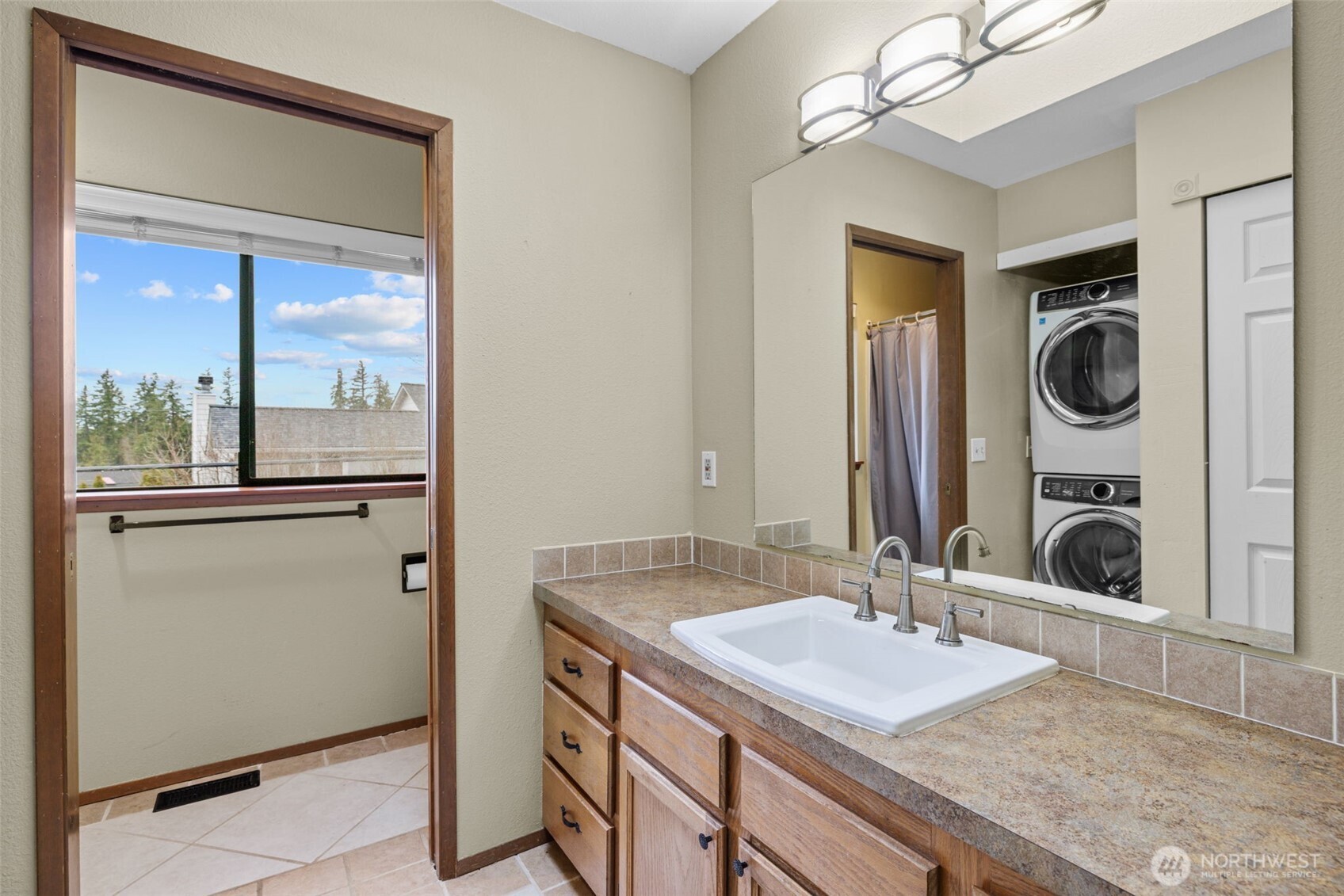 21641 Southeast 266th Street Maple Valley, WA 98038 - Photo 20 of 40 a bathroom with a sink a mirror and a window