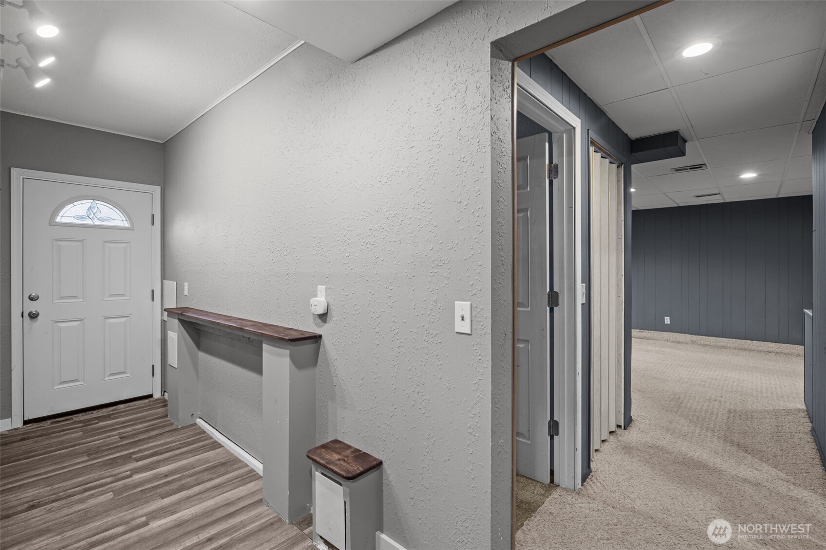 21641 Southeast 266th Street Maple Valley, WA 98038 - Photo 29 of 40 a view of a hallway with wooden floor and staircase