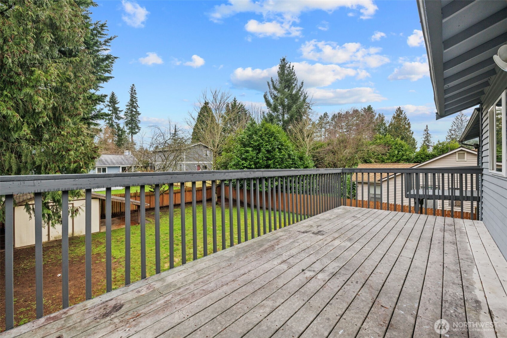 21641 Southeast 266th Street Maple Valley, WA 98038 - Photo 31 of 40 a balcony with wooden floor and fence