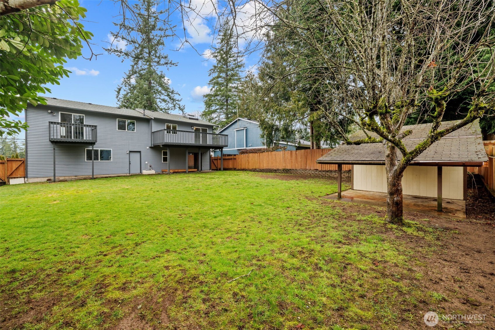 21641 Southeast 266th Street Maple Valley, WA 98038 - Photo 37 of 40 a house that has a tree in front of it