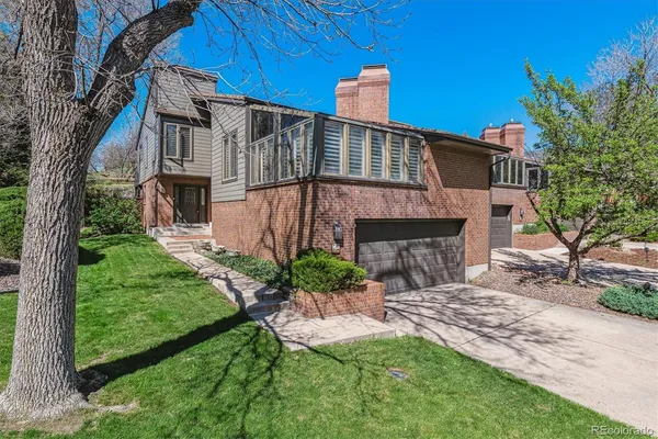 a view of a house with a yard and tree s