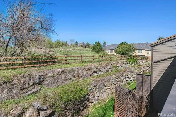 a view of a yard with wooden fence
