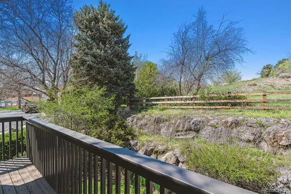 a view of a wooden deck next to a yard