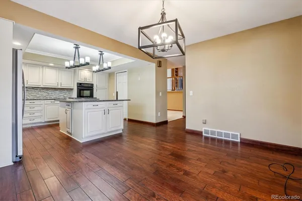 a view of a kitchen with a sink and wooden floor