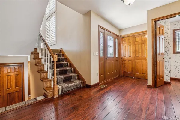 a view of an entryway with wooden floor and door