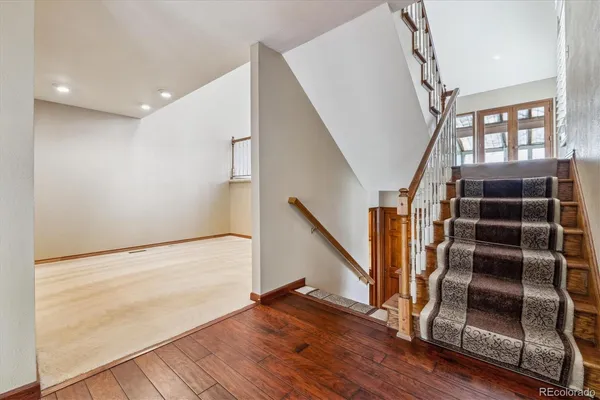 a view of entryway with wooden floor and stairs