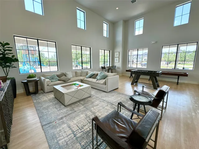 a view of a room with gym equipment and wooden floor