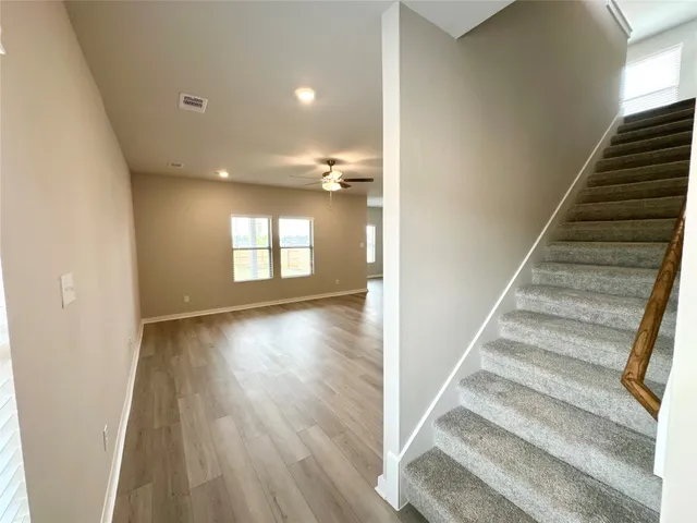 a view of an entryway with wooden floor and stairs