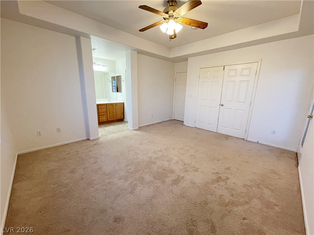 691 Principle Point Avenue Henderson, NV 89012 - Photo 19 of 30 A comfortable bedroom with a practical layout, leading to an adjoining bath area.