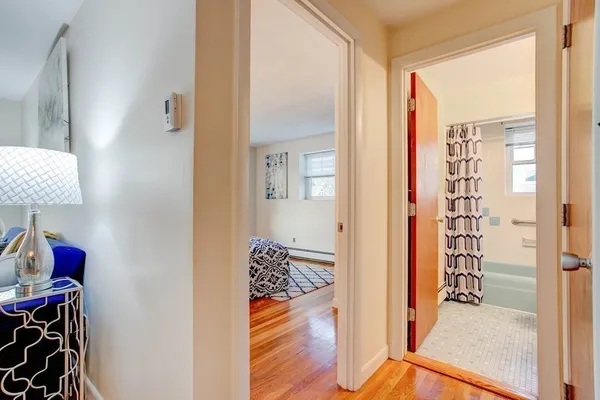 a view of a livingroom with wooden floor and a chandelier