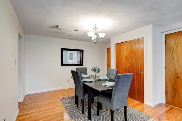 a view of a dining room with furniture and a chandelier