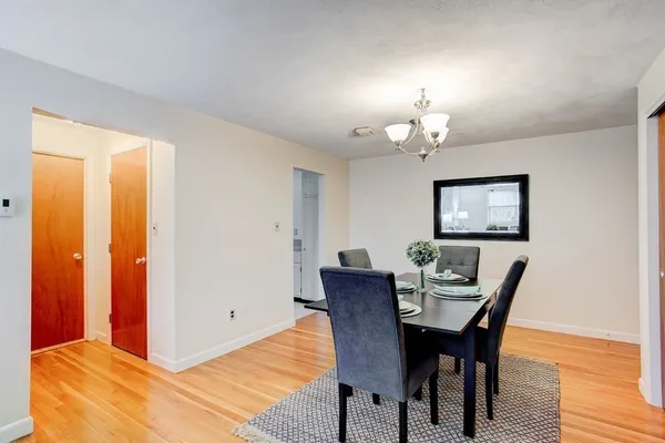 a view of a dining room with furniture and chandelier