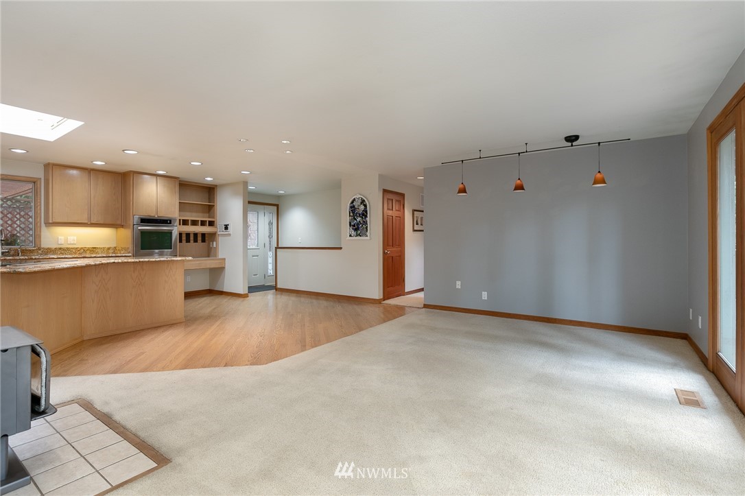 231 Poppy Road Bothell, WA 98012 - Photo 4 of 21 a view of a kitchen with a sink and a refrigerator