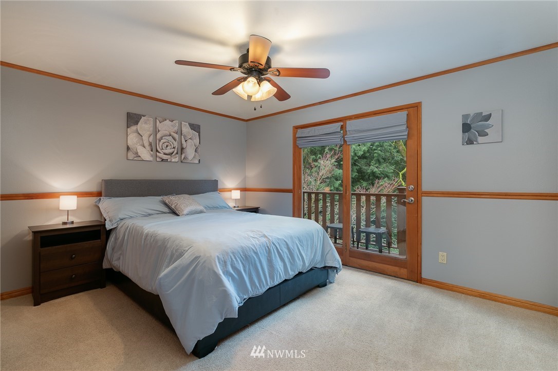 231 Poppy Road Bothell, WA 98012 - Photo 8 of 21 a bedroom with a large bed and a window