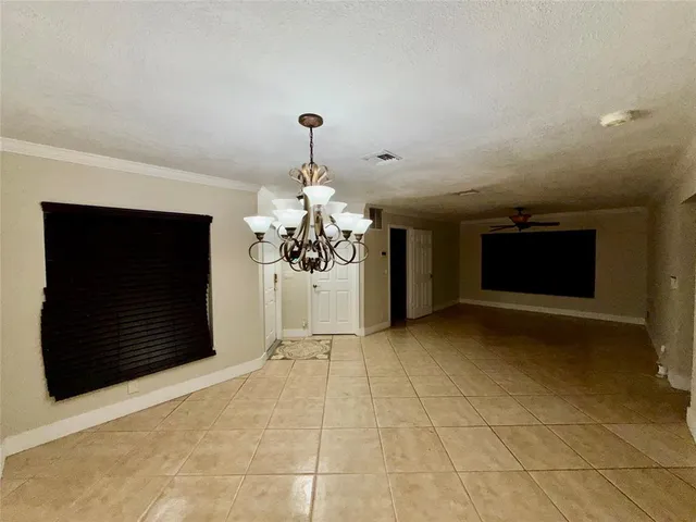 a view of a livingroom with wooden floor and a ceiling fan